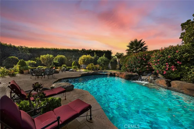a dining room with furniture a chandelier and wooden floor