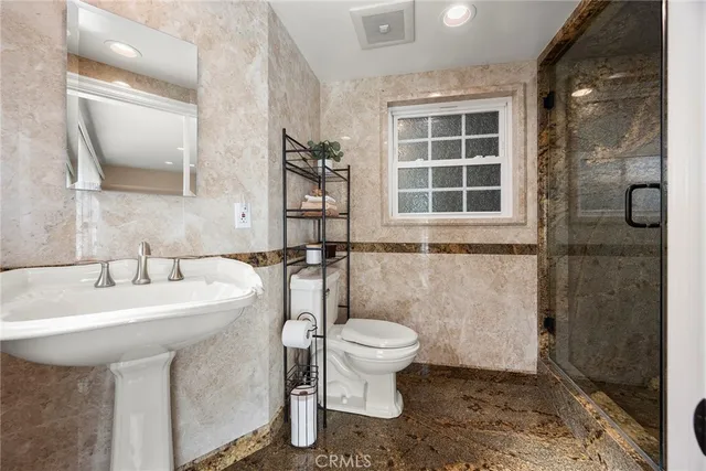 a view of a house with backyard swimming pool and sitting area