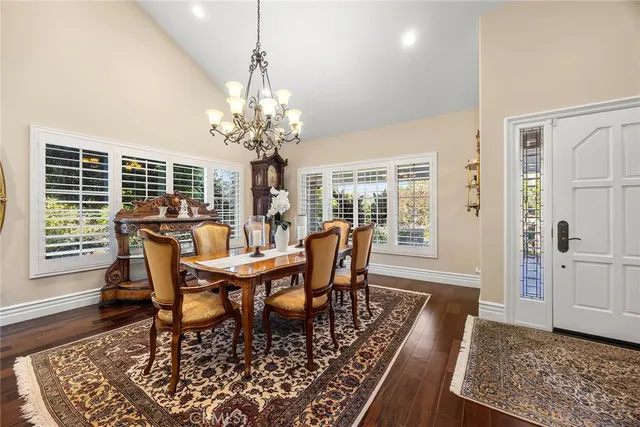 a kitchen with stainless steel appliances granite countertop a sink a stove and a wooden floors