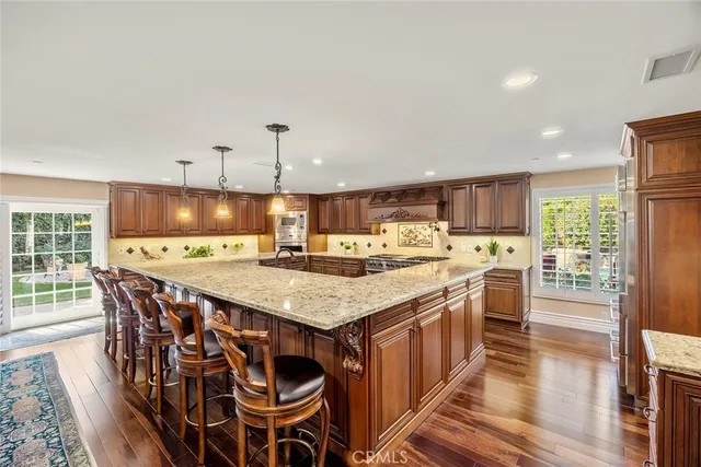 a kitchen with wooden floors and stainless steel appliances