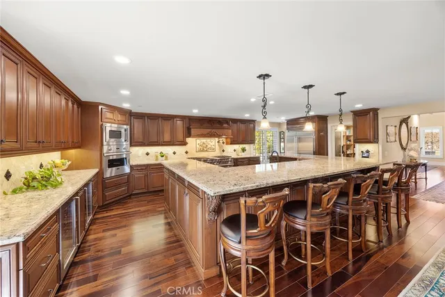 a kitchen with stainless steel appliances and wooden cabinets