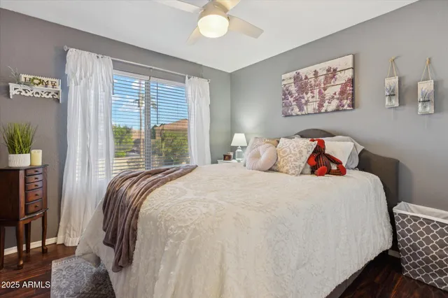 a bedroom with bed and a large window