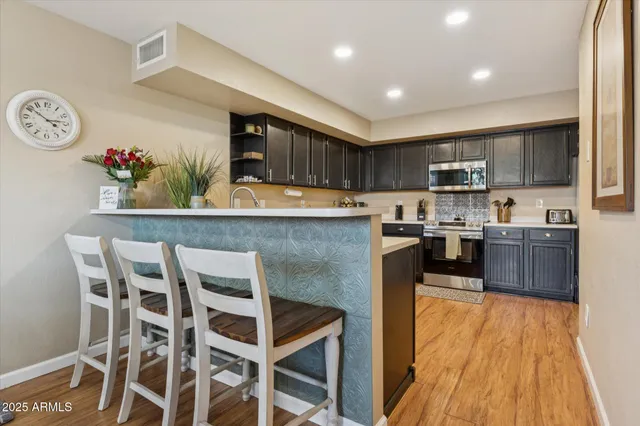 a kitchen with granite countertop counter space a sink appliances and cabinets