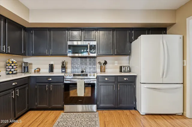 a kitchen with a sink a stove and cabinets