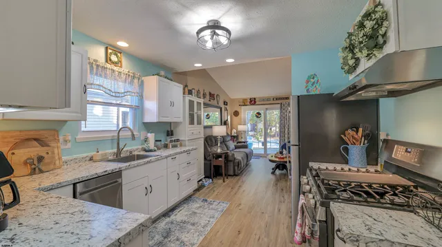 a kitchen with a stove a sink and a refrigerator