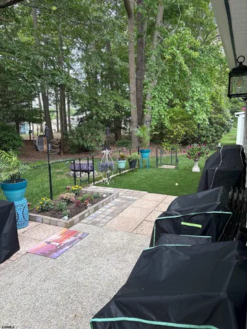 a view of a backyard with table and chairs