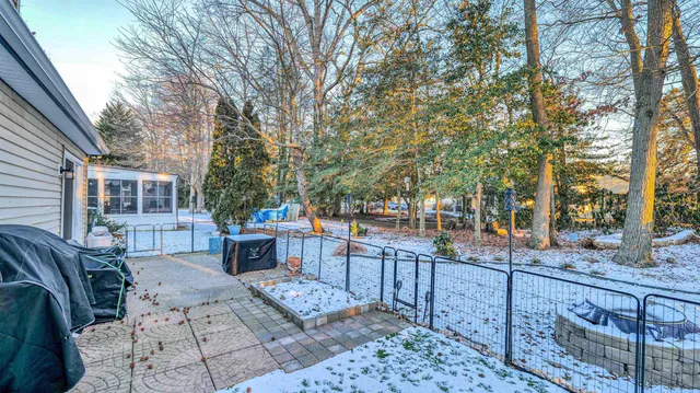 a view of a patio with table and chairs and wooden fence