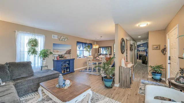 a living room with furniture a window and a table