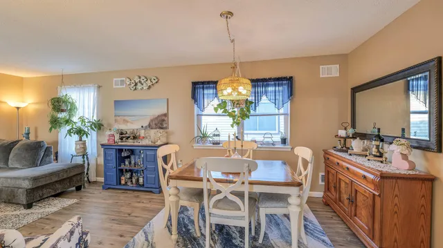 a view of a dining room with furniture window and wooden floor