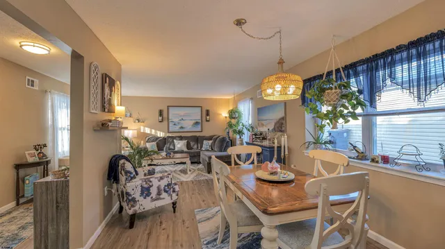 a view of a dining room with furniture window and wooden floor