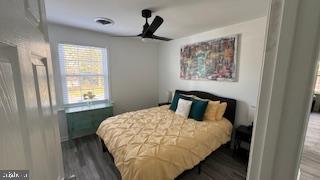 1546 Savannah Road Lewes, DE 19958 - Photo 3 of 8 a bedroom with a bed and wooden floor