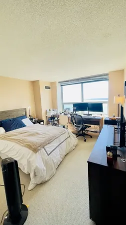 a bedroom with bed and window