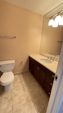 a bathroom with a sink a toilet and a mirror