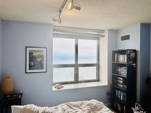 a bedroom with a bed and a window