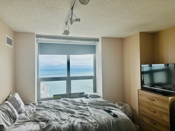 a bedroom with a bed and a flat screen tv