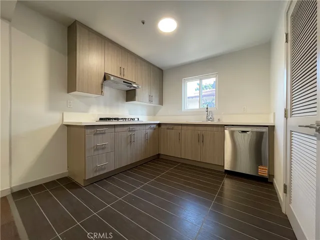 a kitchen with stainless steel appliances a sink stove and cabinets