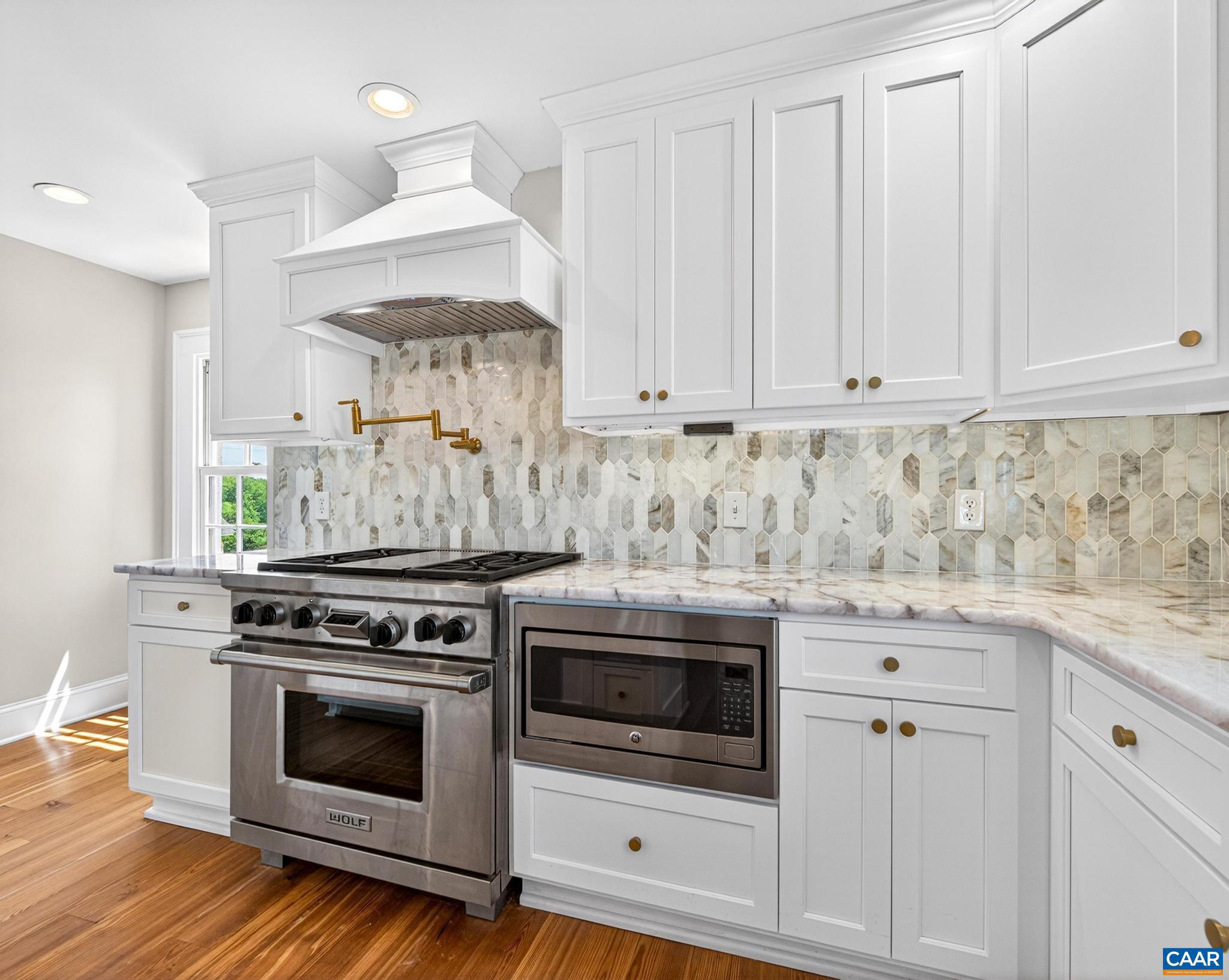 481 Race Ground Road Somerset, VA 22972 - Photo 16 of 53 a kitchen with granite countertop white cabinets and white appliances