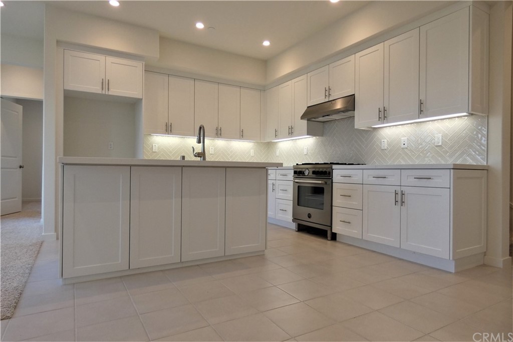 206 Oak Forest Irvine, CA 92618 - Photo 12 of 42 a kitchen with stainless steel appliances granite countertop white cabinets and sink