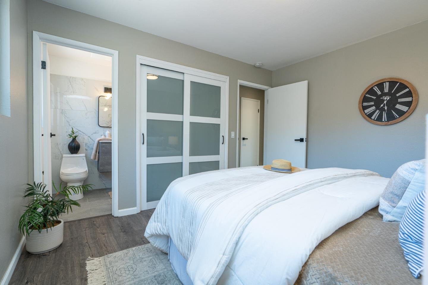 1055 Tweed Street Seaside, CA 93955 - Photo 13 of 33 a bedroom with a bed and a potted plant