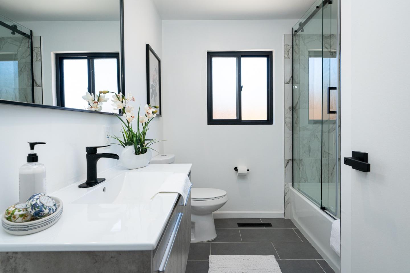 1055 Tweed Street Seaside, CA 93955 - Photo 17 of 33 a bathroom with a sink a toilet and a mirror