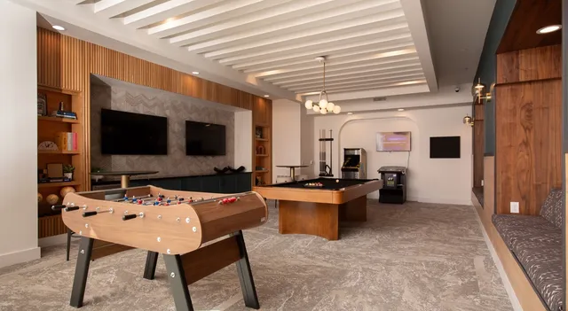 a living room with furniture fireplace and a large window