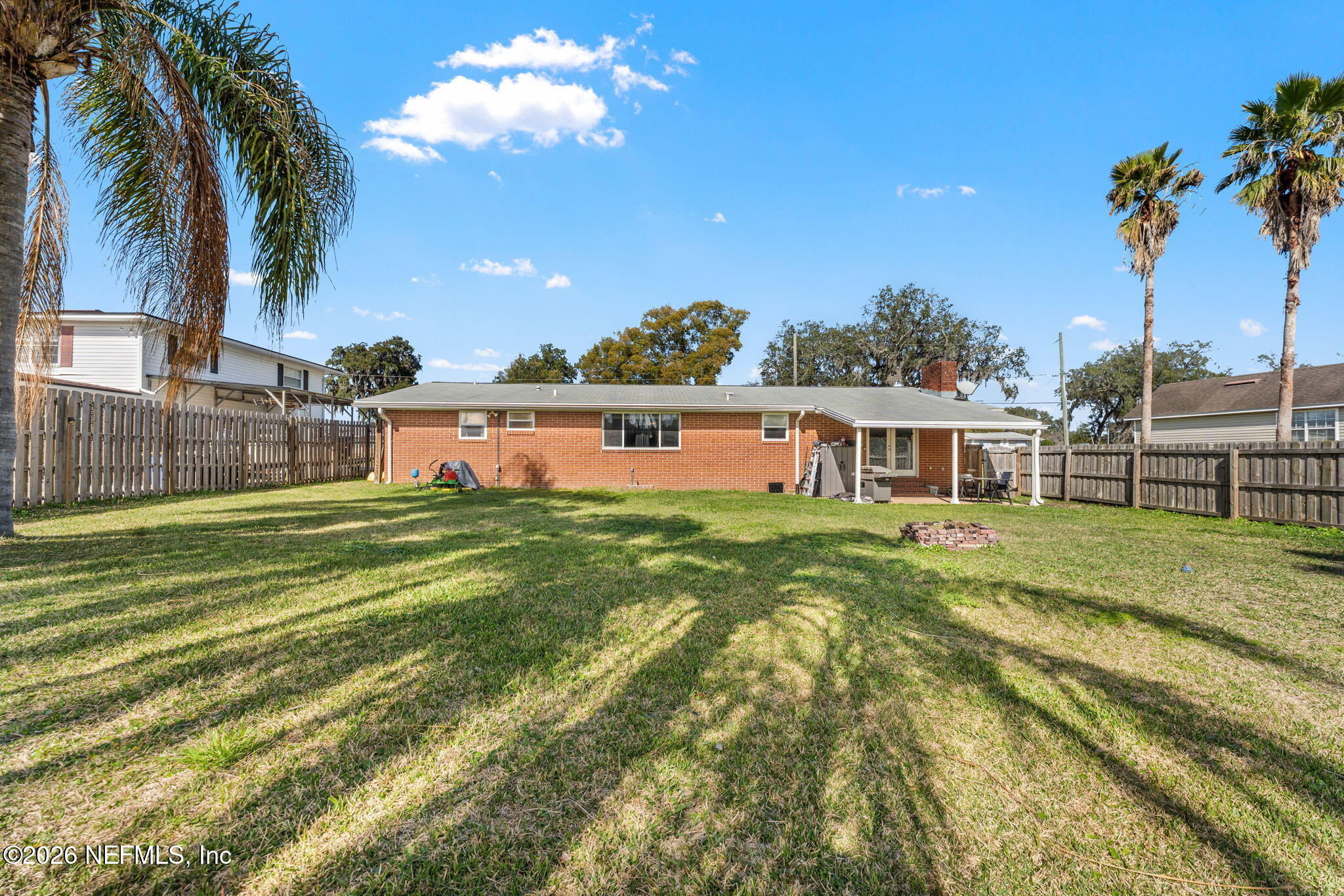 284 Baisden Road Jacksonville, FL 32218 - Photo 13 of 39 a view of a lake with a big yard and palm trees