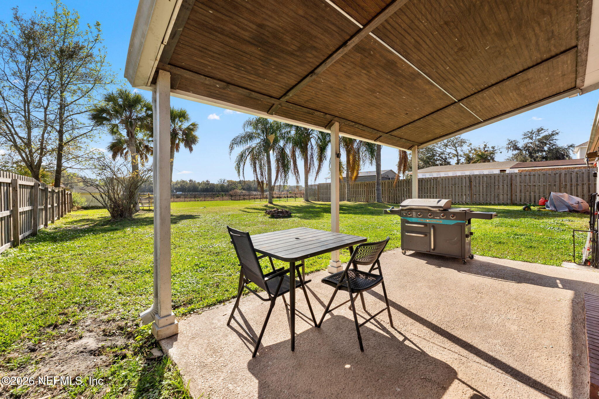 284 Baisden Road Jacksonville, FL 32218 - Photo 15 of 39 a view of a chairs and table in patio with a backyard