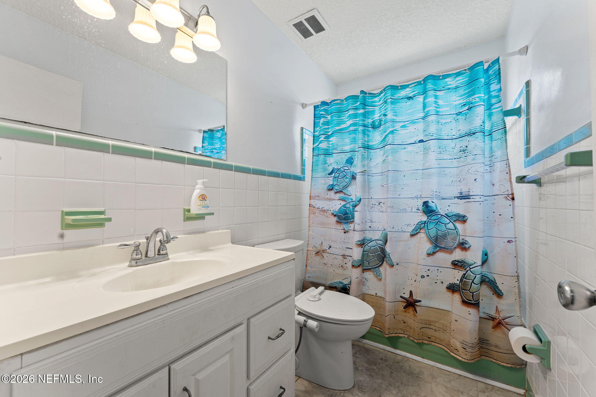 284 Baisden Road Jacksonville, FL 32218 - Photo 20 of 39 a bathroom with a sink a toilet and shower curtain