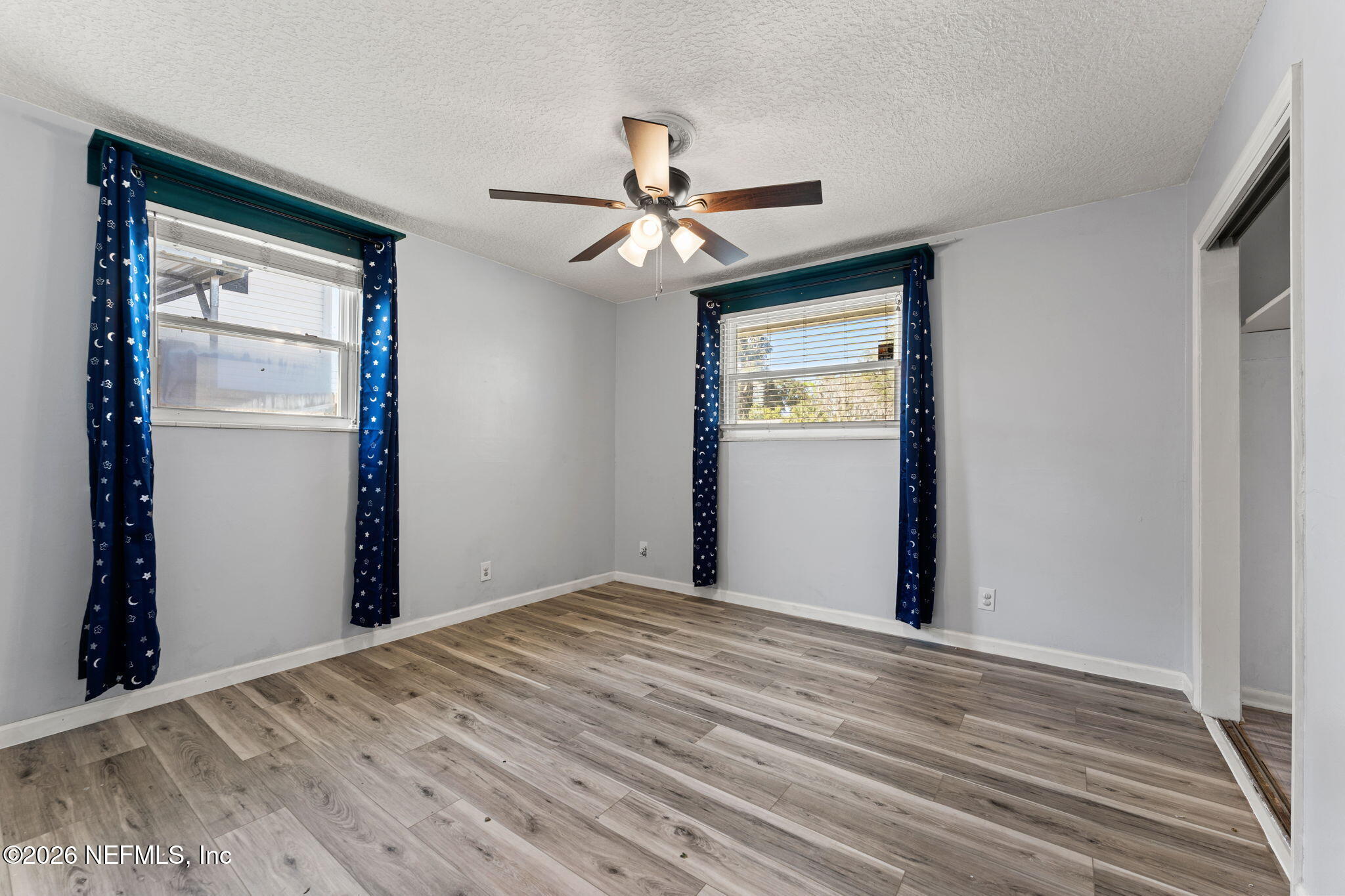 284 Baisden Road Jacksonville, FL 32218 - Photo 21 of 39 a view of a room with a ceiling fan and hardwood floor