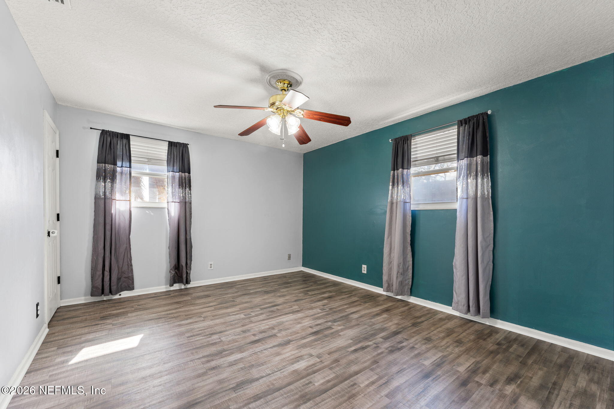 284 Baisden Road Jacksonville, FL 32218 - Photo 25 of 39 a view of a room with a chandelier fan and a large window