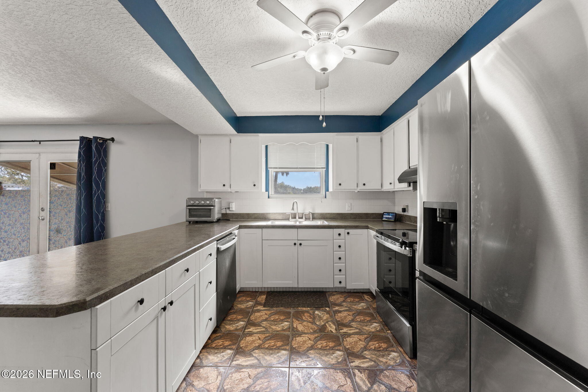 284 Baisden Road Jacksonville, FL 32218 - Photo 33 of 39 a kitchen with granite countertop stainless steel appliances sink and cabinets