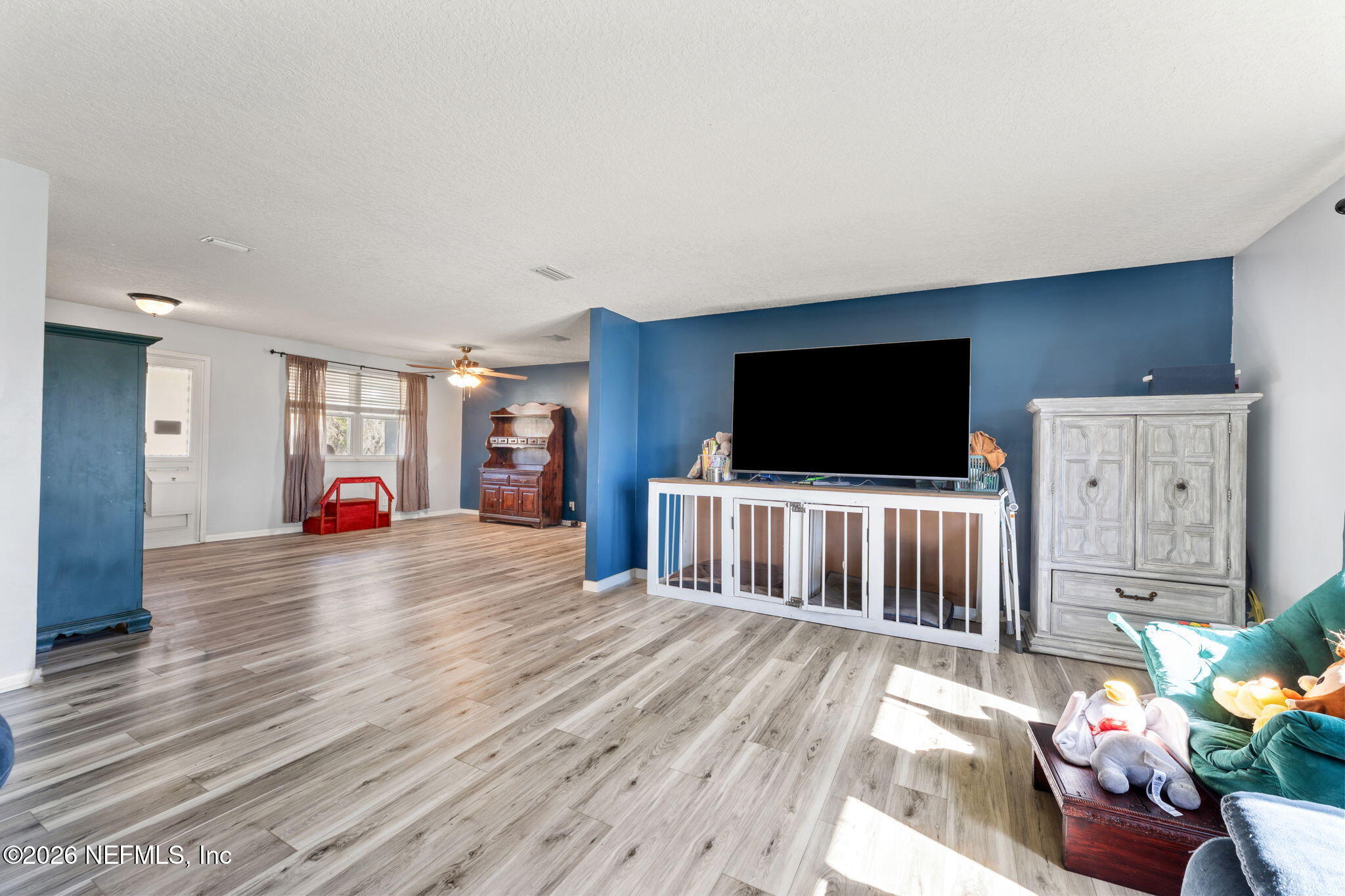 284 Baisden Road Jacksonville, FL 32218 - Photo 35 of 39 a living room with furniture and a flat screen tv