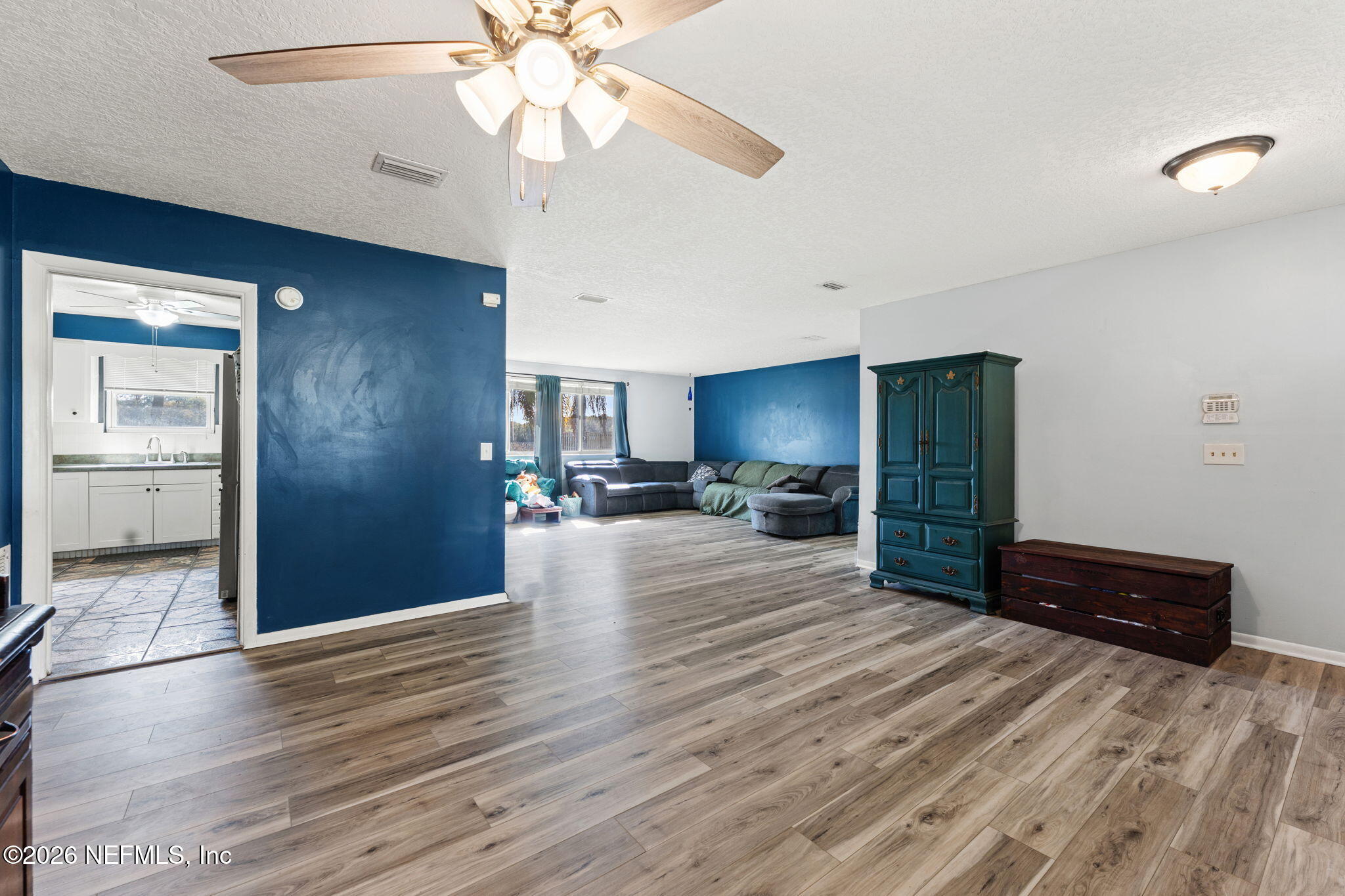 284 Baisden Road Jacksonville, FL 32218 - Photo 38 of 39 a view of a livingroom with wooden floor and a ceiling fan
