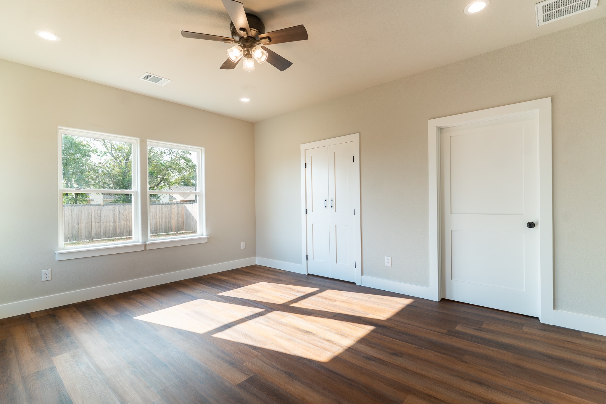 305 String Prairie Way Smithville, TX 78957 - Photo 11 of 26 a view of empty room with wooden floor and fan
