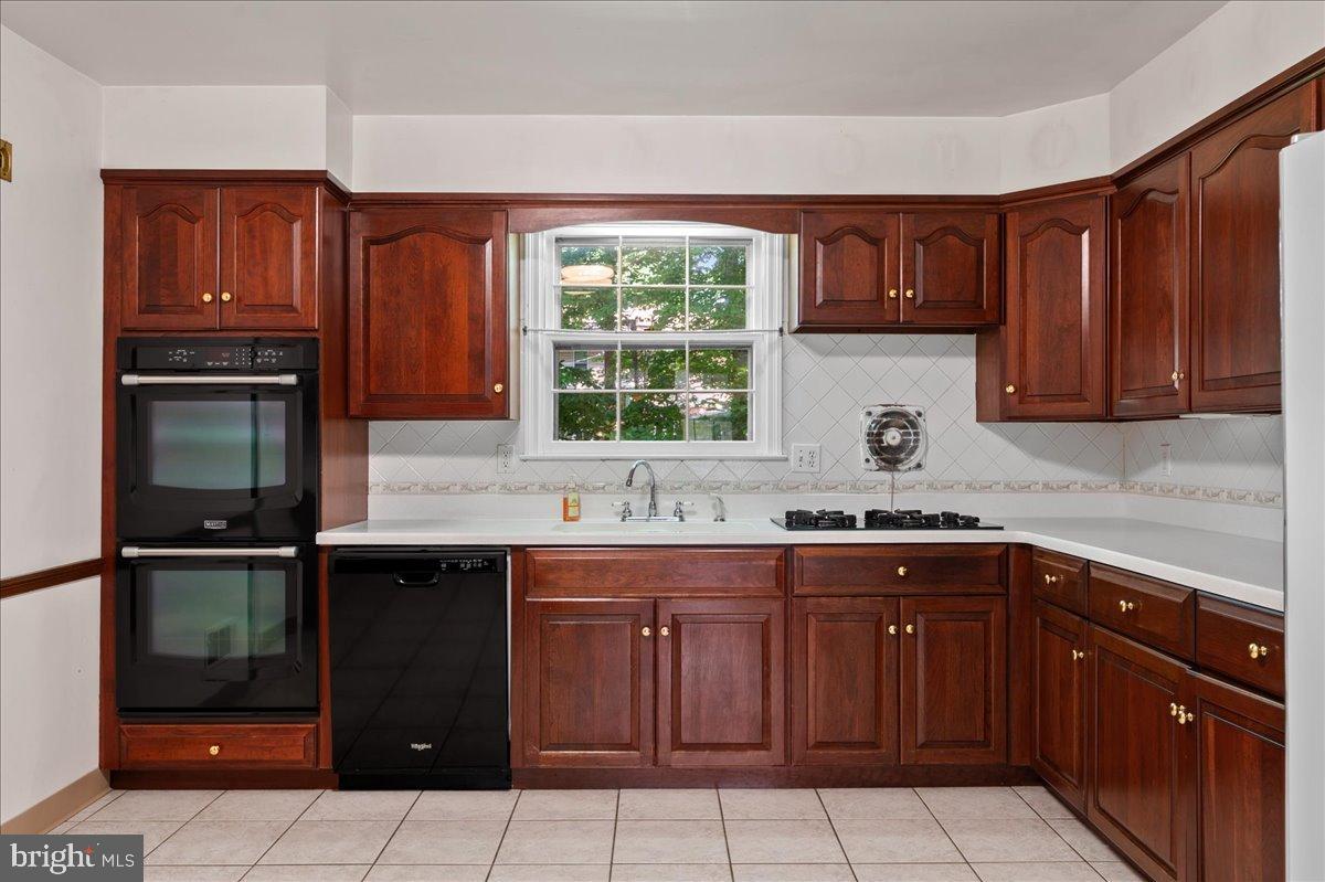 2539 Raven Road Wilmington, DE 19810 - Photo 15 of 39 Warm wood cabinetry in a bright kitchen.