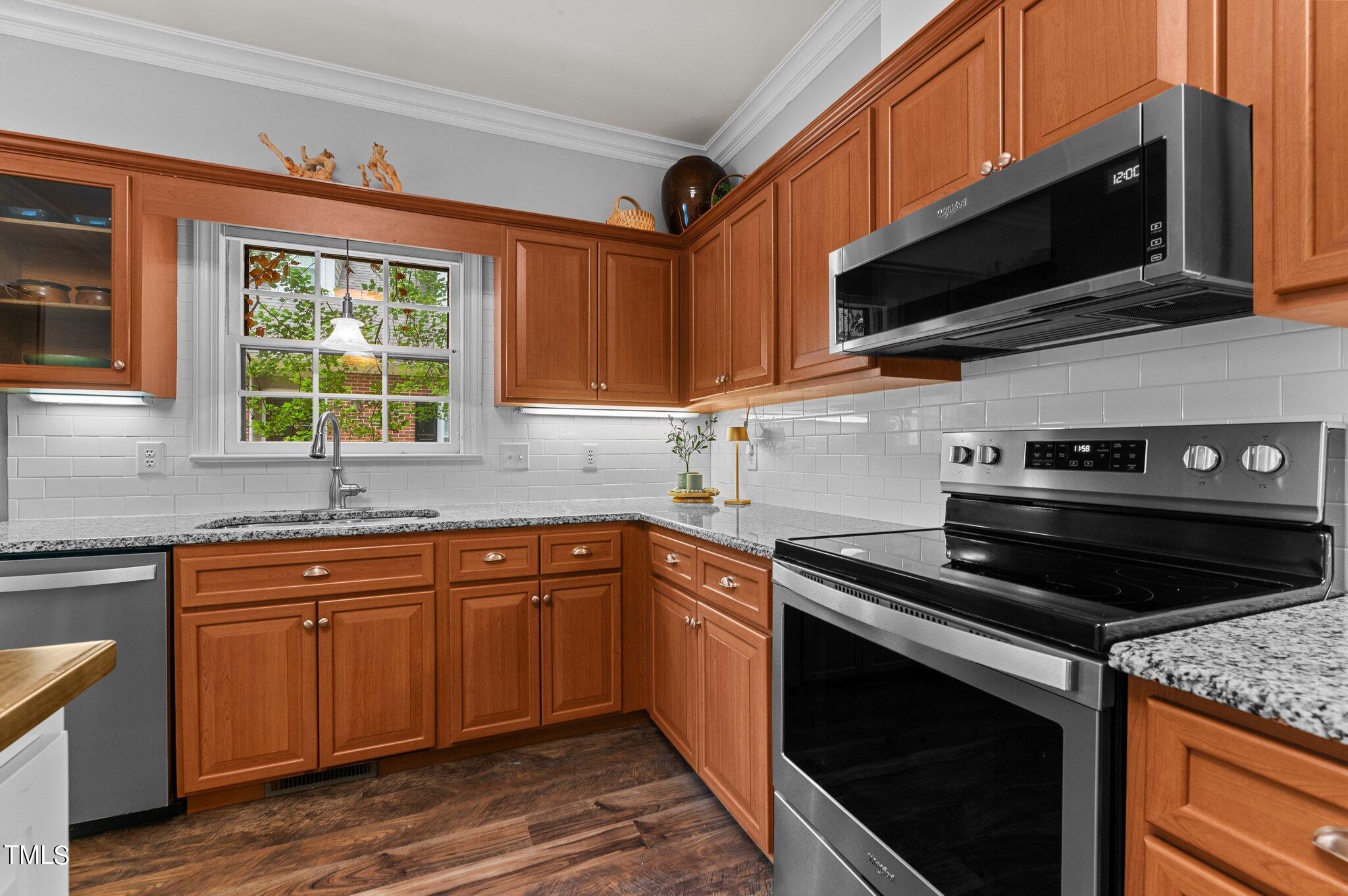 736 Weathergreen Drive Raleigh, NC 27615 - Photo 8 of 43 a kitchen with a sink stove and microwave