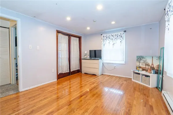 a view of a kitchen with wooden floor and electronic appliances