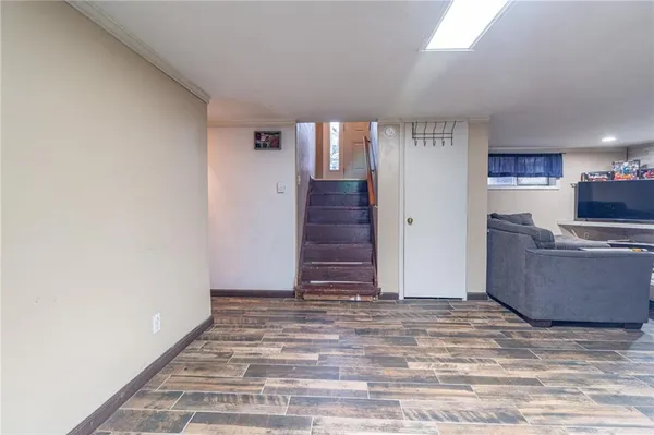 a view of a room with wooden floor and stairs