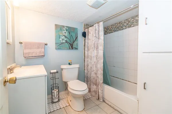 a white toilet sitting next to a bathroom sink