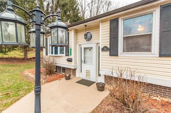 a front view of a house with a yard outdoor seating and garage