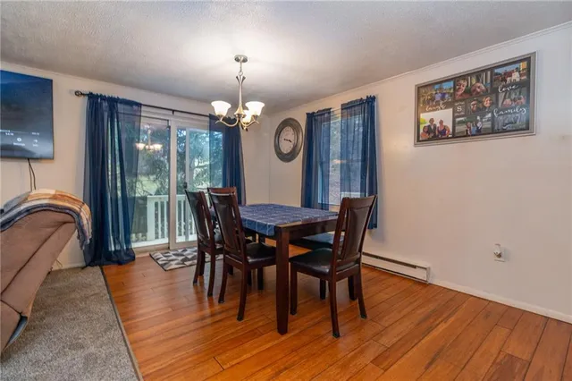 a view of a dining room with furniture and chandelier