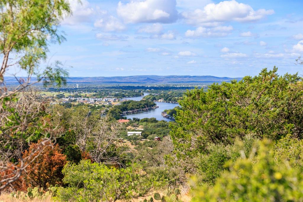 Undisclosed Address Burnet, TX 78611 - Photo 18 of 29 a view of a lake with houses in the back