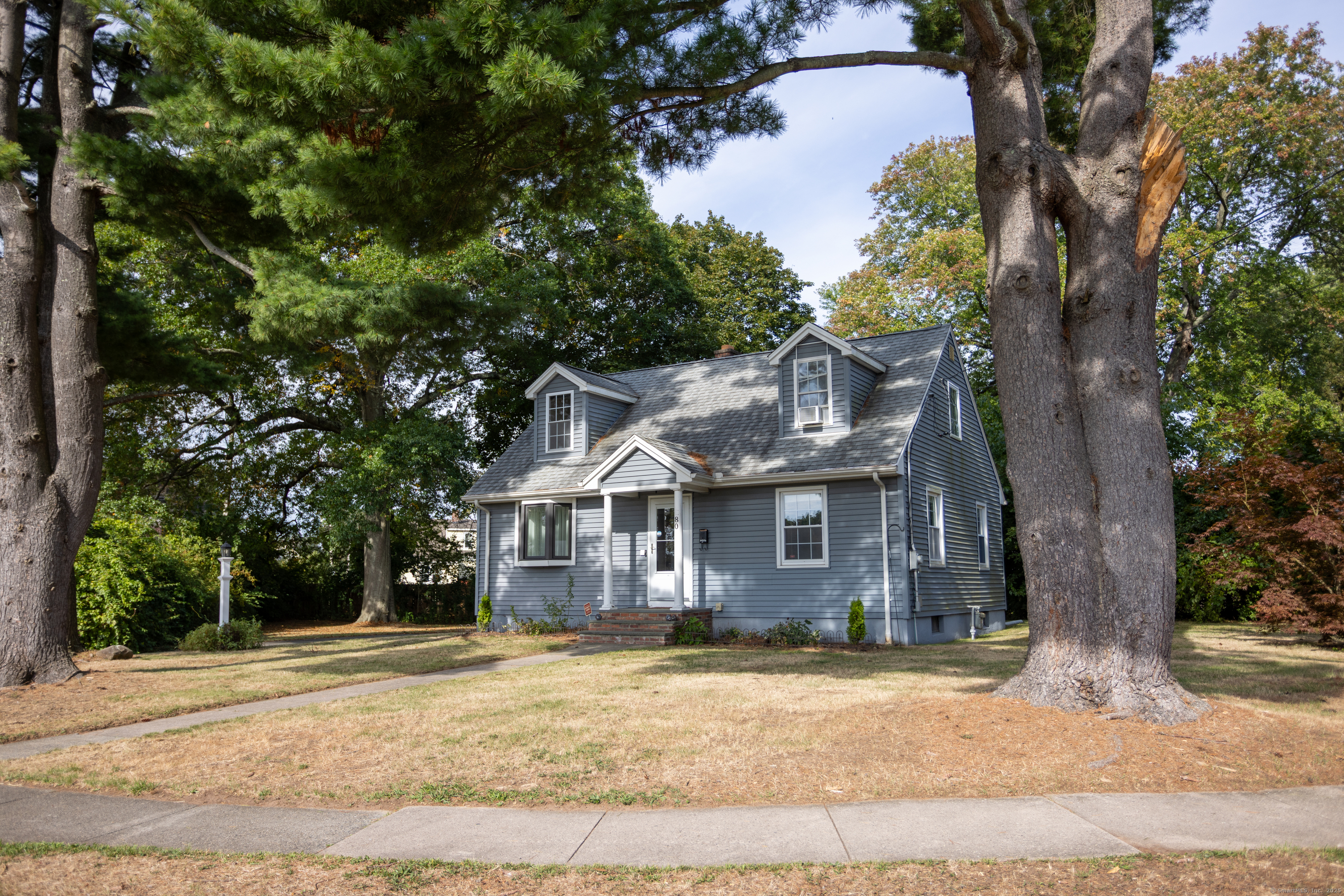 80 Noble Street Hamden, CT 06514 - Photo 3 of 22 a front view of a house with a yard and garage
