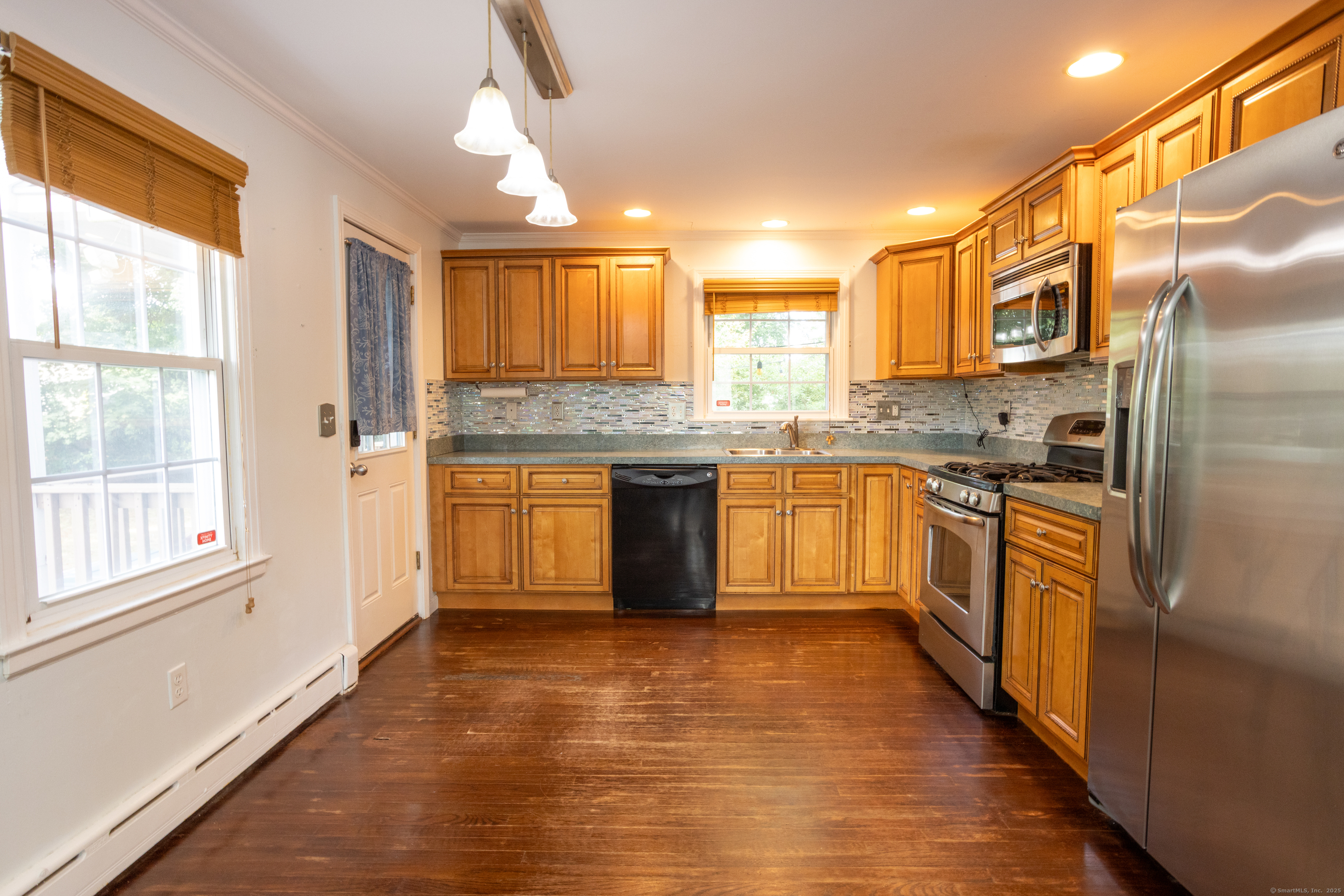 80 Noble Street Hamden, CT 06514 - Photo 7 of 22 a kitchen with stainless steel appliances granite countertop a stove a sink dishwasher a refrigerator and white cabinets with wooden floor