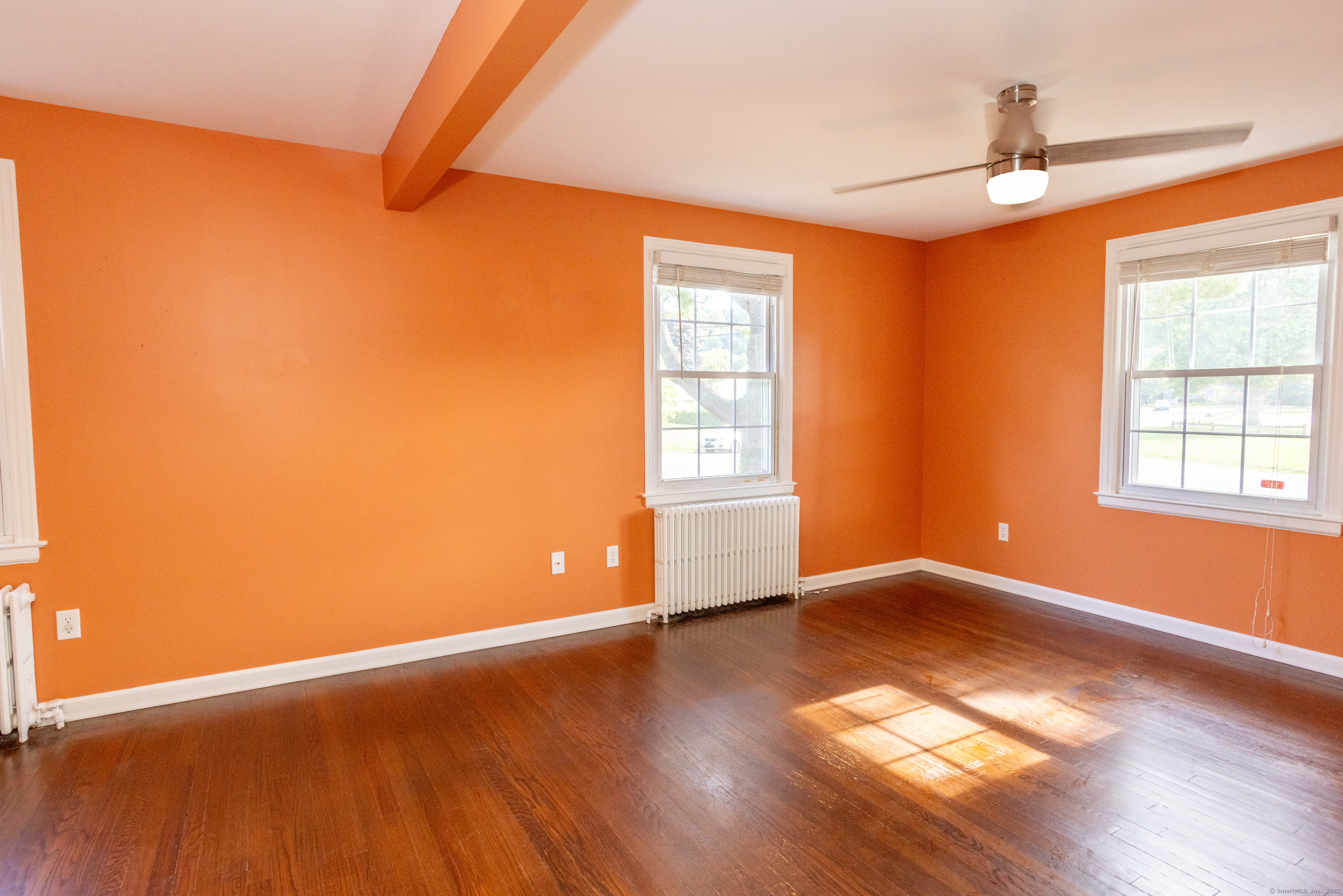 80 Noble Street Hamden, CT 06514 - Photo 8 of 22 an empty room with wooden floor and windows