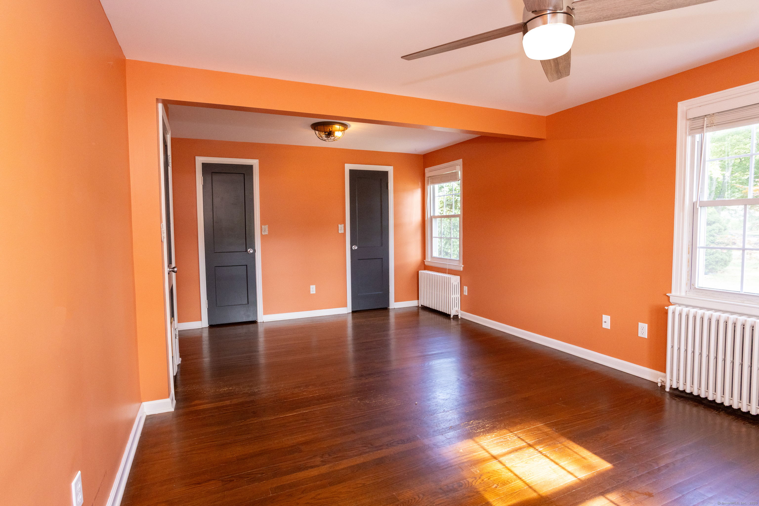 80 Noble Street Hamden, CT 06514 - Photo 9 of 22 a view of empty room with wooden floor and fan