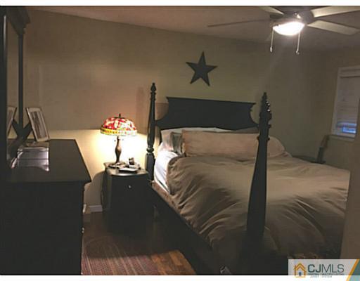 21 Albemarle Road Colonia, NJ 07067 - Photo 10 of 22 a bed sitting in a bedroom next to a lamp