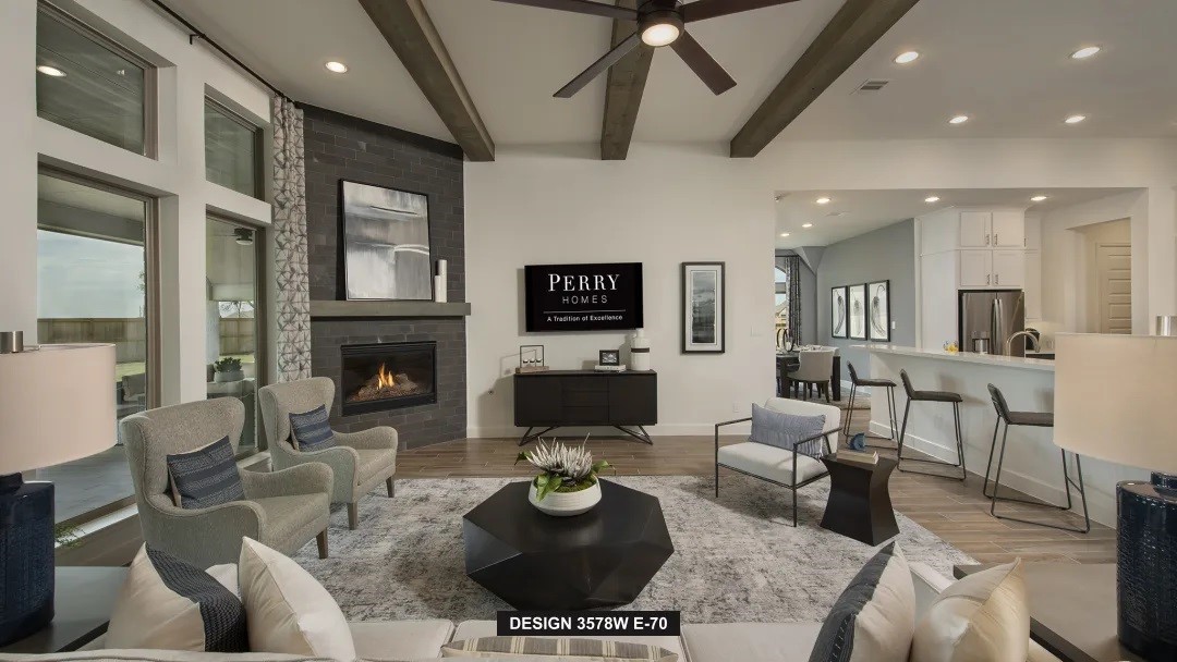 5302 Dream Court Manvel, TX 77578 - Photo 2 of 20 a living room with furniture a fireplace and a flat screen tv