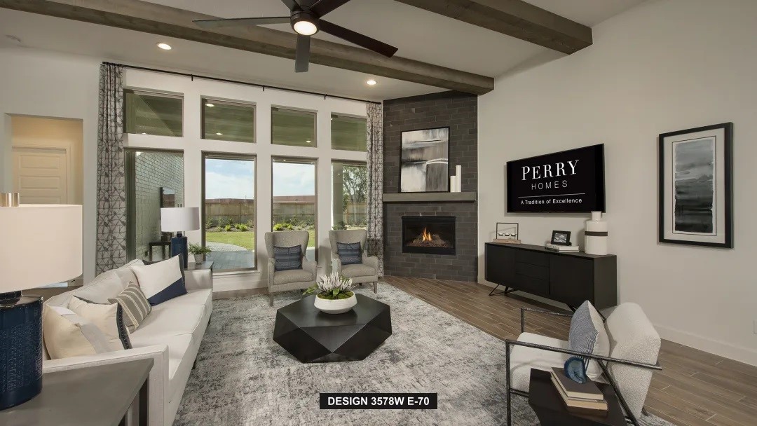 5302 Dream Court Manvel, TX 77578 - Photo 3 of 20 a living room with furniture a flat screen tv and a fireplace