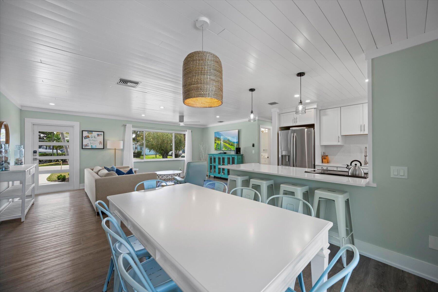 1389 Southwest Dyer Point Road Palm City, FL 34990 - Photo 19 of 55 a view of a dining room with furniture and wooden floor